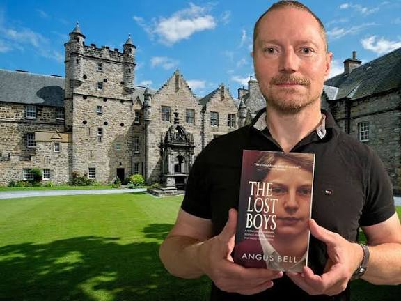 Angus Bell. 'The School' behind him
